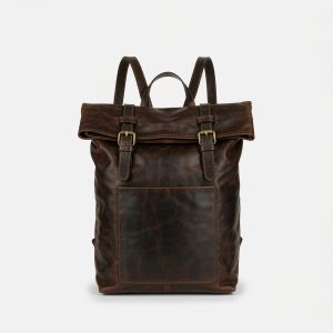 Chestnut full-grain leather backpack with a roll-top flap and brass buckles