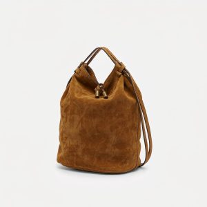 Caramel suede mini bucket bag with a drawstring closure